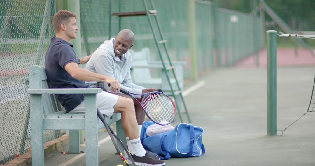 Two Friends Relaxing on Tennis Court Bench After Game - Free Images, Stock Photos and Pictures on Pikwizard.com