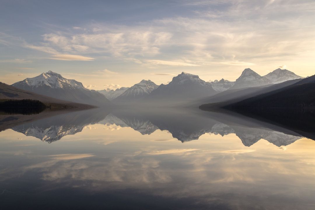 Serene Mountain Lake with Reflective Water and Majestic Sky - Free Images, Stock Photos and Pictures on Pikwizard.com