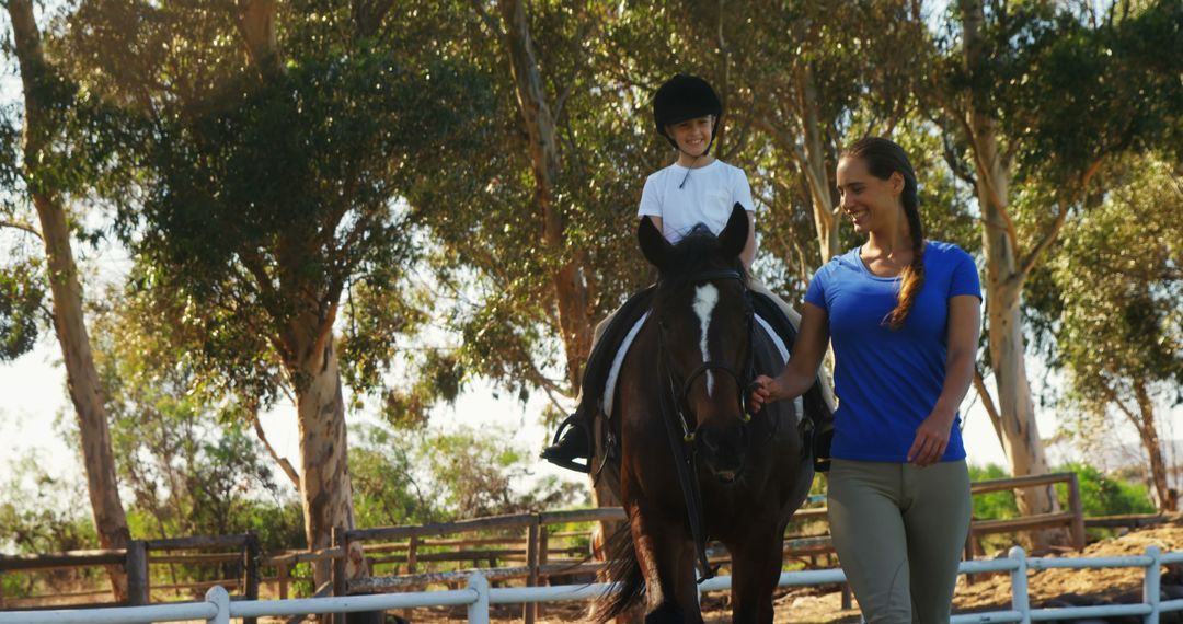 Young Girl Learning Horse Riding with Instructor in Outdoor Arena - Free Images, Stock Photos and Pictures on Pikwizard.com