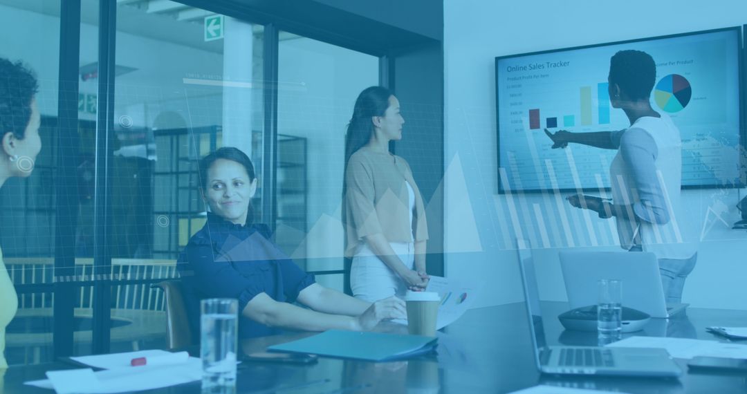 Diverse Team Analyzing Digital Sales Data Presented in Office Meeting