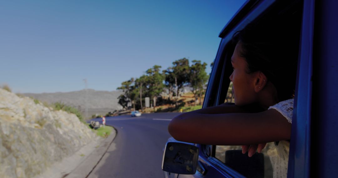 Young Woman Enjoying Scenic Road Trip with Clear Blue Sky - Free Images, Stock Photos and Pictures on Pikwizard.com