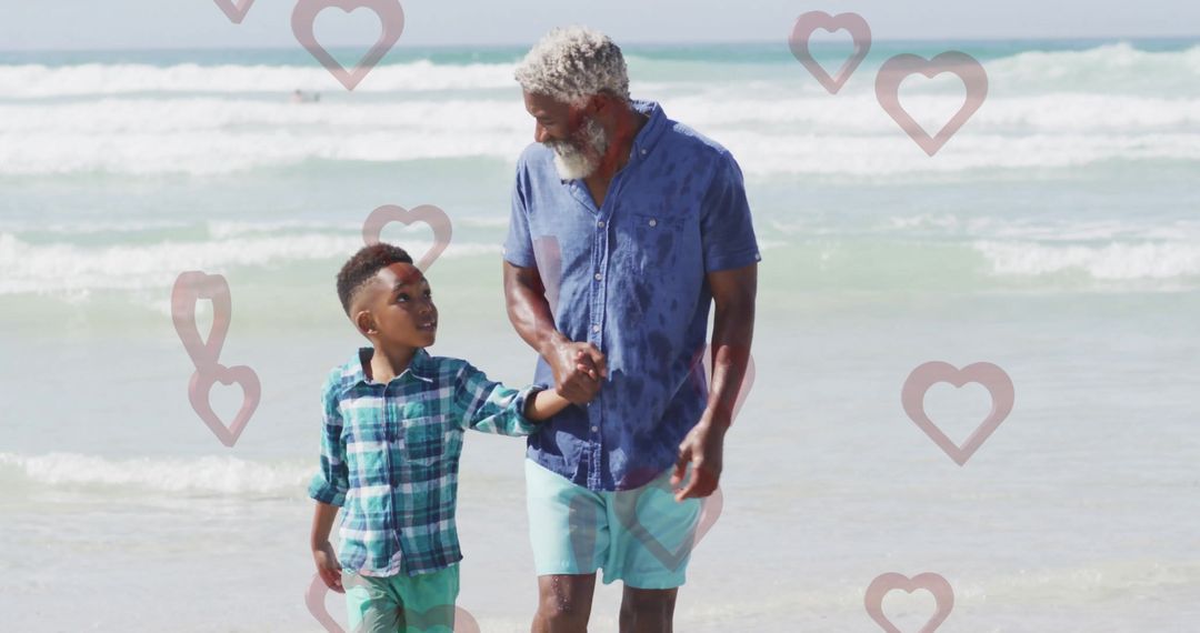 Grandfather and Grandson Enjoy Beach Walk with Floating Hearts