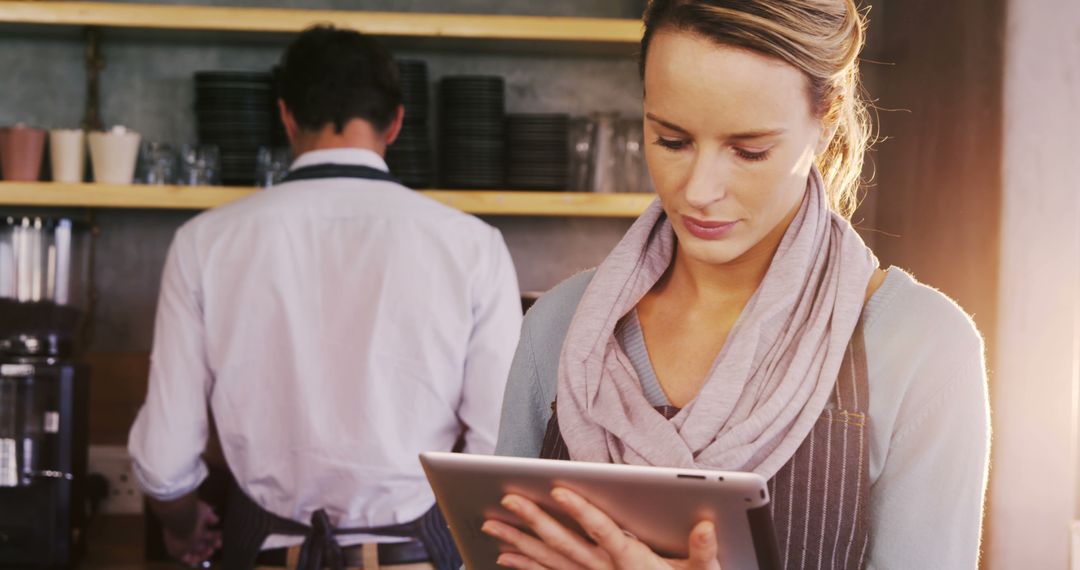 Female Barista Using Digital Tablet in Coffee Shop - Free Images, Stock Photos and Pictures on Pikwizard.com