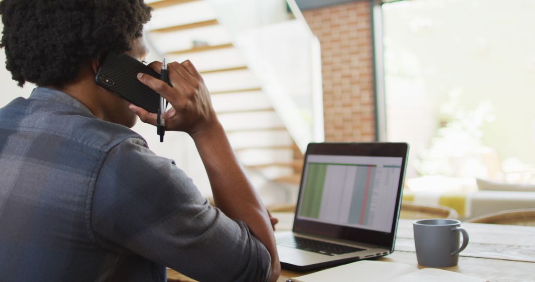 Man Remotely Working and Networking via Laptop and Mobile
