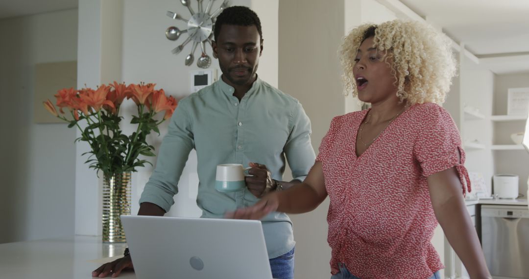 Friends Engaging and Conversing Over Laptop at Home