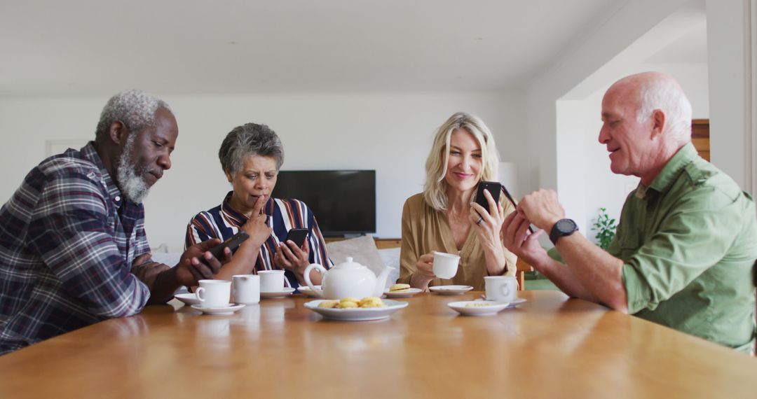 Senior Friends Enjoying Tea and Using Smartphones Together - Free Images, Stock Photos and Pictures on Pikwizard.com