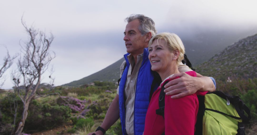 Middle-aged couple hiking in scenic mountainous landscape - Free Images, Stock Photos and Pictures on Pikwizard.com