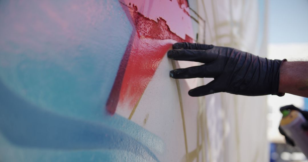 Close-Up of Street Artist Using Red Spray Paint on Wall - Free Images, Stock Photos and Pictures on Pikwizard.com