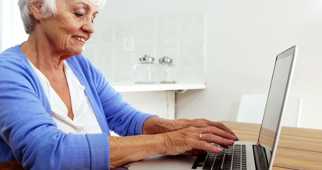 Smiling Senior Woman Using Laptop at Home - Free Images, Stock Photos and Pictures on Pikwizard.com