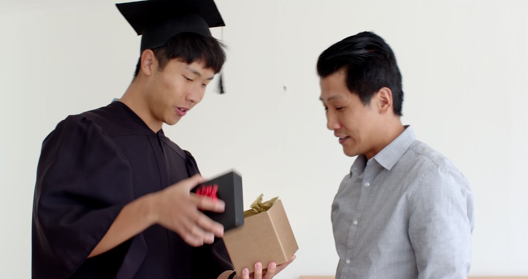Father Congratulating Son on Graduation Achievement at Home