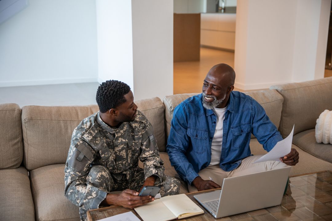 Father Supporting Military Son with Paperwork at Home