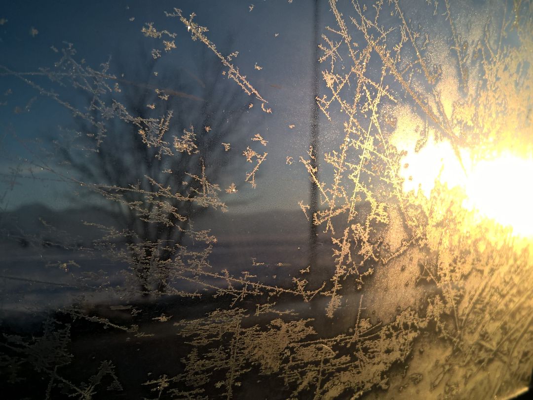 Frost Patterns on Window with Sunrise Background - Free Images, Stock Photos and Pictures on Pikwizard.com