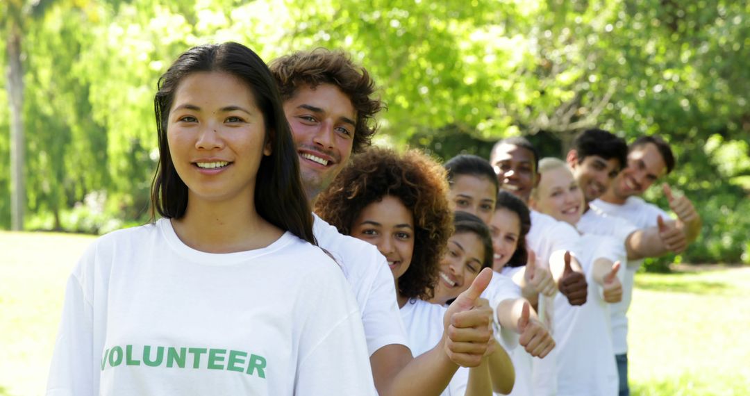 Diverse Group of Enthusiastic Volunteers Giving Thumbs Up Outdoors - Free Images, Stock Photos and Pictures on Pikwizard.com