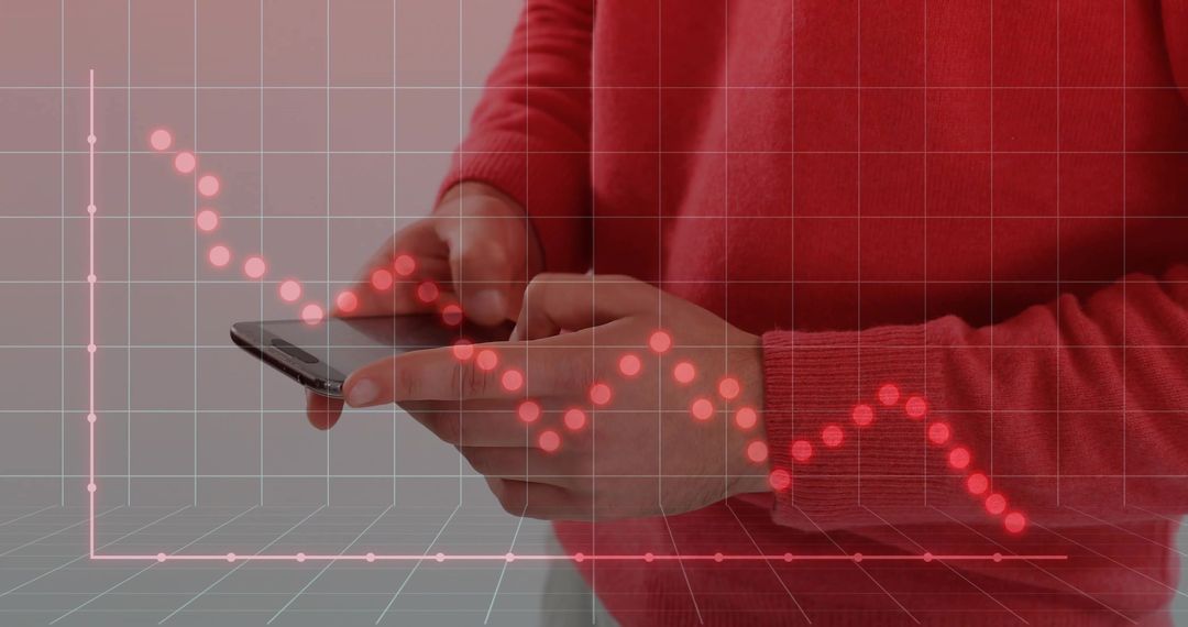 Hands Holding Smartphone with Red Declining Financial Graph Overlay Showing Market Downturn