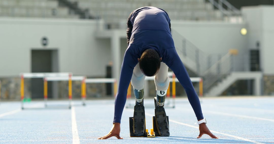 Athlete with Prosthetic Legs Starting at Track Race - Free Images, Stock Photos and Pictures on Pikwizard.com