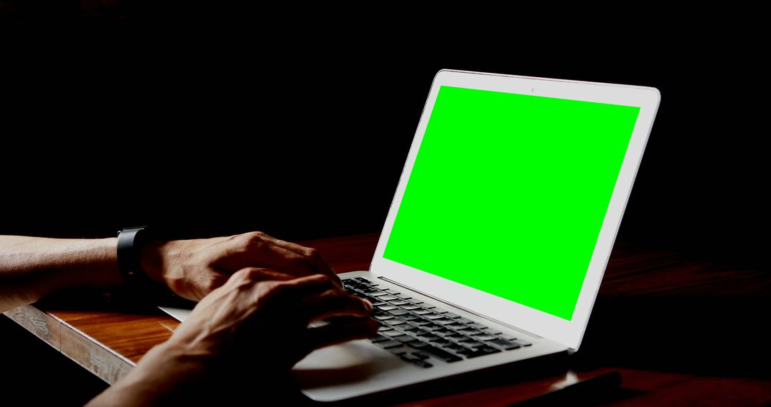 Person Typing on Laptop with Green Screen in Dim Light - Free Images, Stock Photos and Pictures on Pikwizard.com