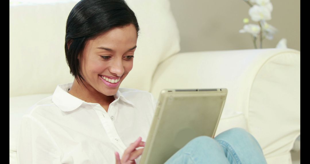 Smiling Woman Using Tablet Indoors - Free Images, Stock Photos and Pictures on Pikwizard.com