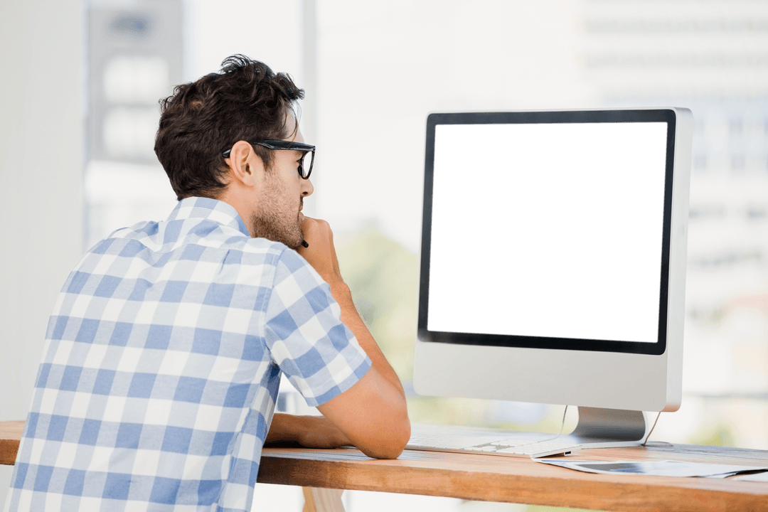 Man Wearing Checkered Shirt Staring at Transparent Computer Screen