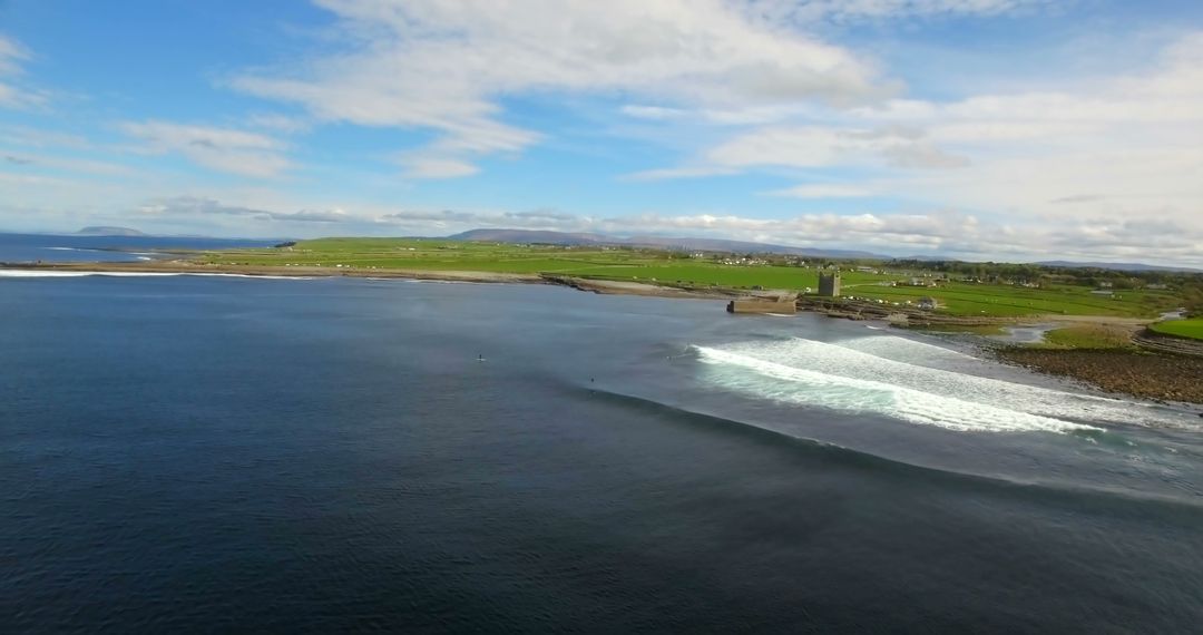 Scenic Coastal Landscape with Rolling Waves and Green Pastures - Free Images, Stock Photos and Pictures on Pikwizard.com