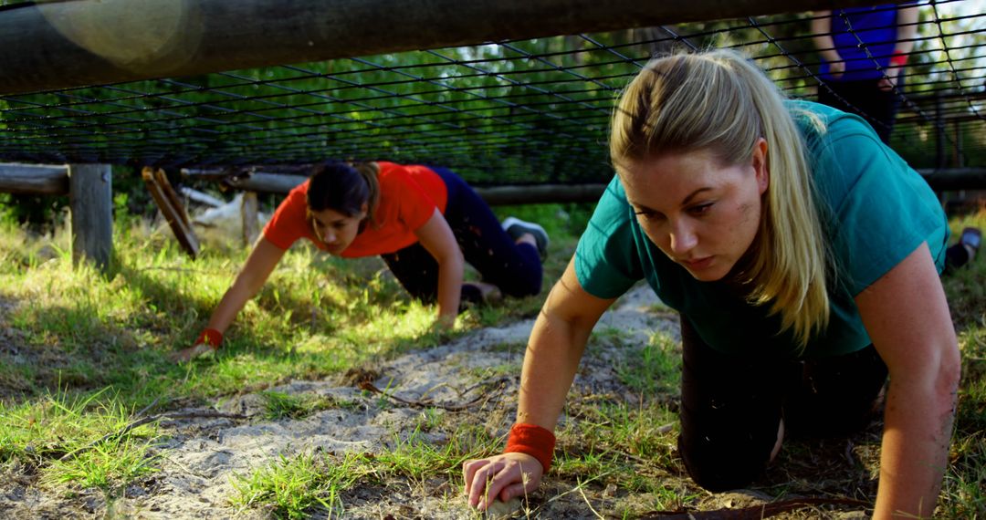 Women Crawling Under Obstacle in Outdoor Training Course - Free Images, Stock Photos and Pictures on Pikwizard.com