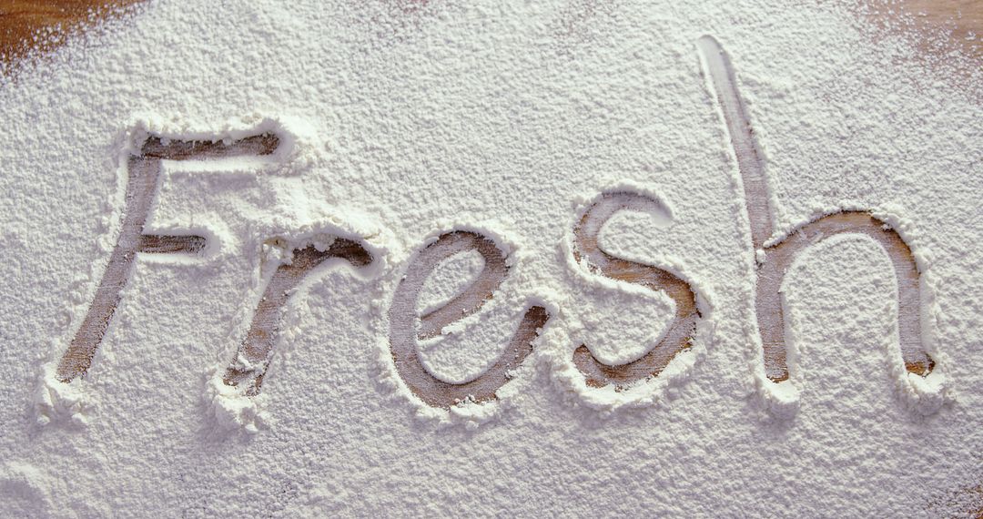 The word Fresh is written in a dusting of white flour on a wooden surface, with copy space - Free Images, Stock Photos and Pictures on Pikwizard.com