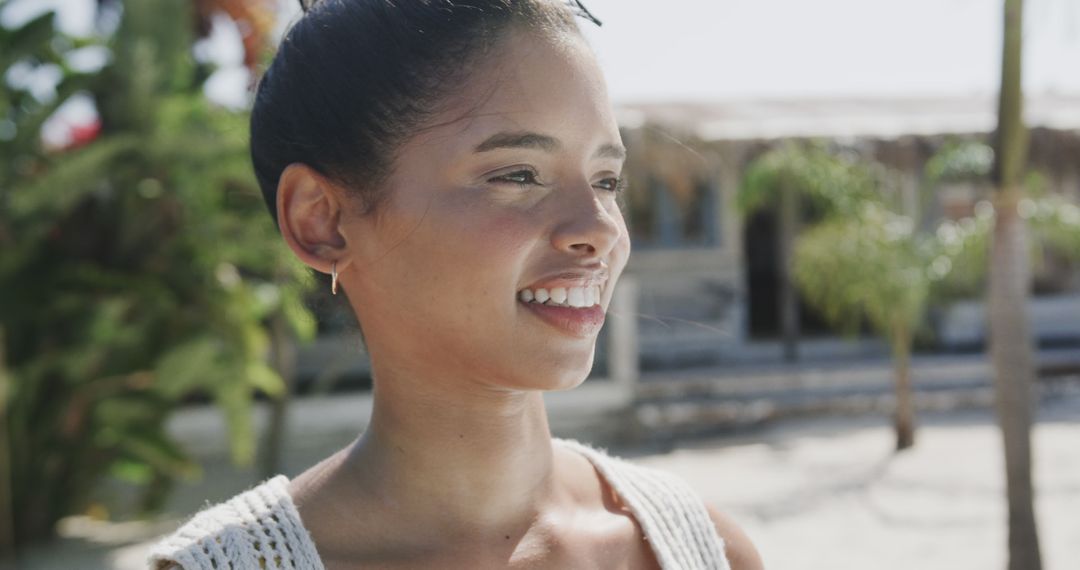 Smiling Woman Enjoying Tropical Vacation on a Sunny Day - Free Images, Stock Photos and Pictures on Pikwizard.com