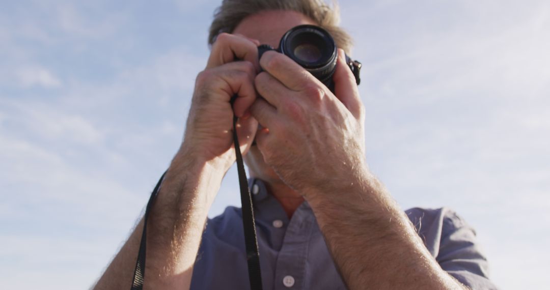 Photographer Capturing Landscape with Camera on Clear Day - Free Images, Stock Photos and Pictures on Pikwizard.com