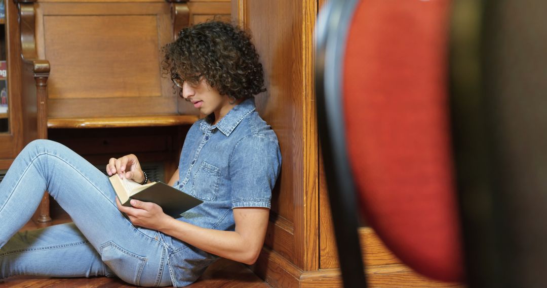 Young Man Enjoying a Book in Very Welcoming Library Corner