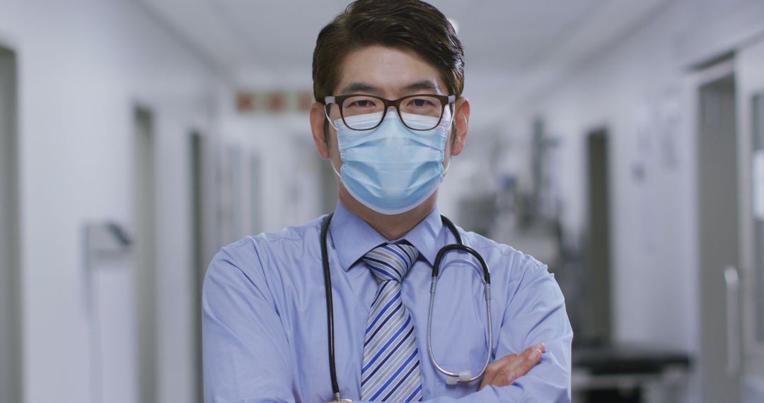 Confident Doctor Wearing Face Mask in Hospital Corridor