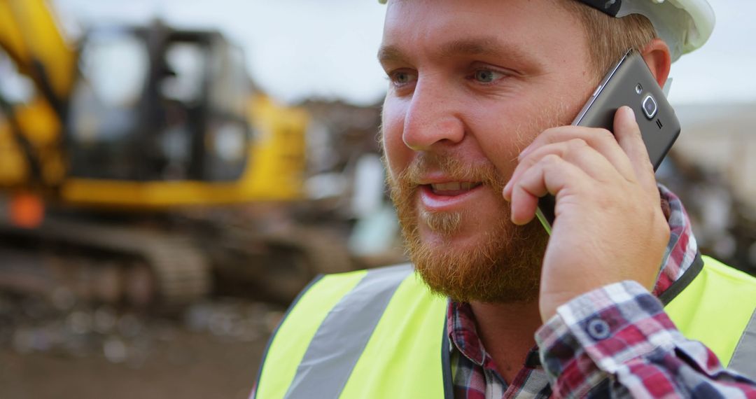 Construction Worker Communicating via Smartphone on Work Site - Free Images, Stock Photos and Pictures on Pikwizard.com