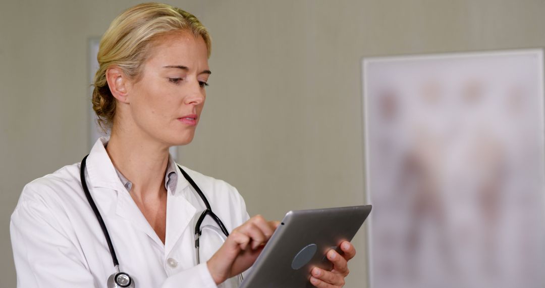 Female Doctor Using Tablet in Medical Office - Free Images, Stock Photos and Pictures on Pikwizard.com