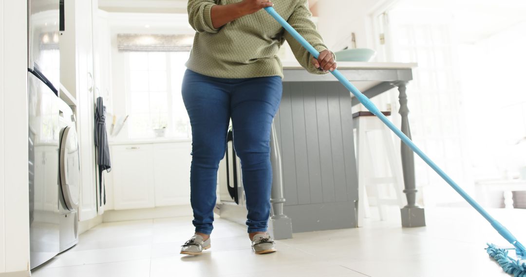 Woman Mopping Floor in Modern Kitchen - Free Images, Stock Photos and Pictures on Pikwizard.com