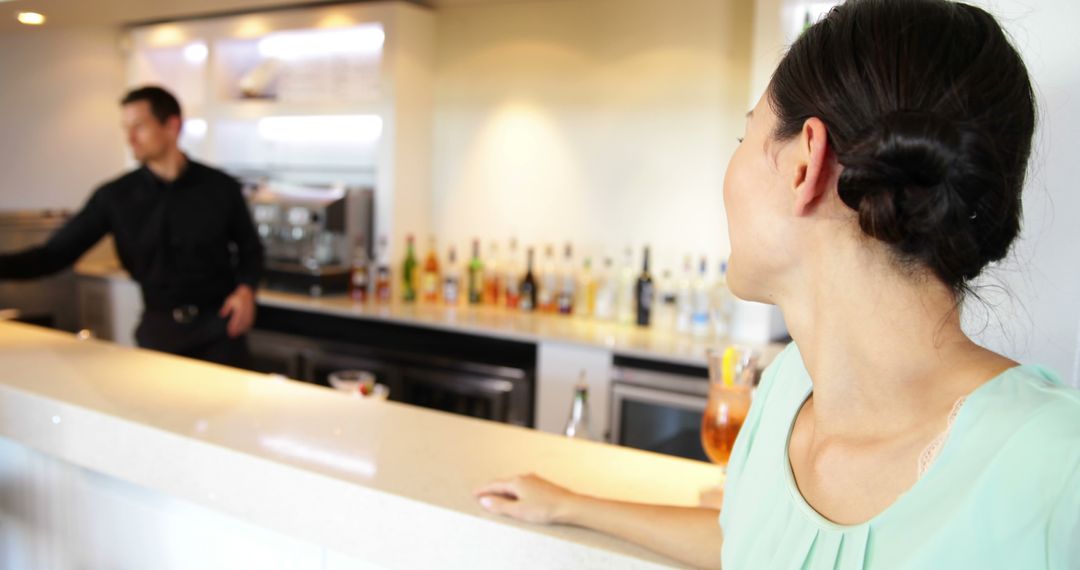 Woman Enjoying Evening Out at Trendy Bar Counter