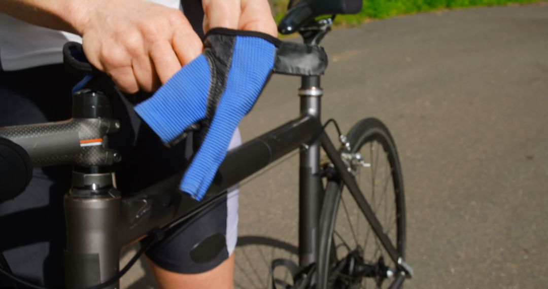 Cyclist Attaching Knee Support Brace Before Outdoor Ride - Free Images, Stock Photos and Pictures on Pikwizard.com