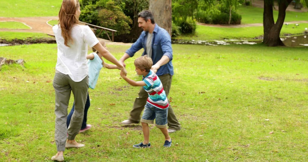 Happy Family Playing Outdoors in Park - Free Images, Stock Photos and Pictures on Pikwizard.com