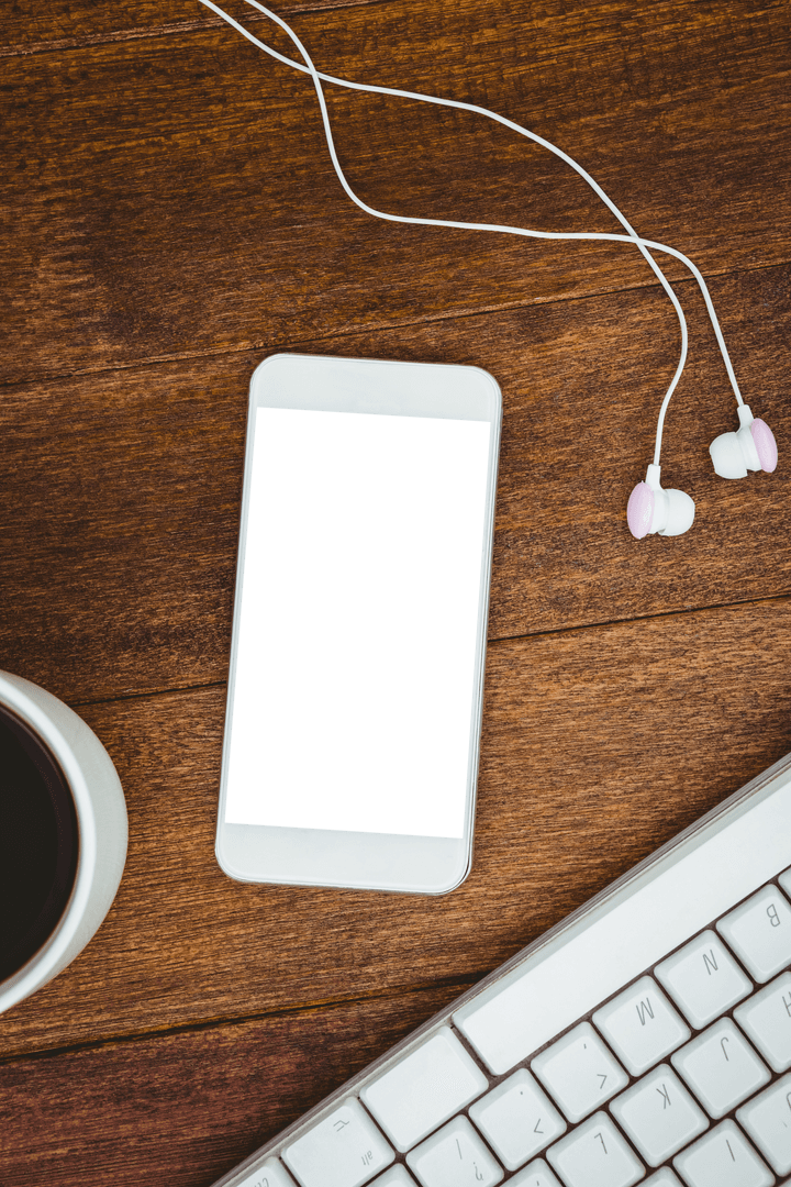 Transparent Smartphone on Wooden Desk with Coffee and Earbuds