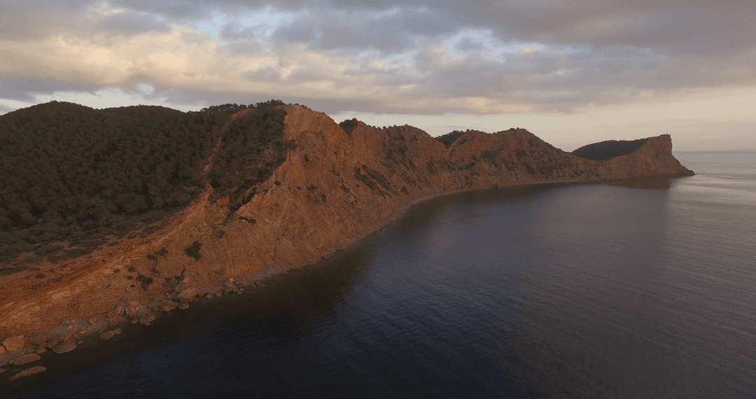 Transparent Coastal Cliffs at Sunset with Cloudy Sky