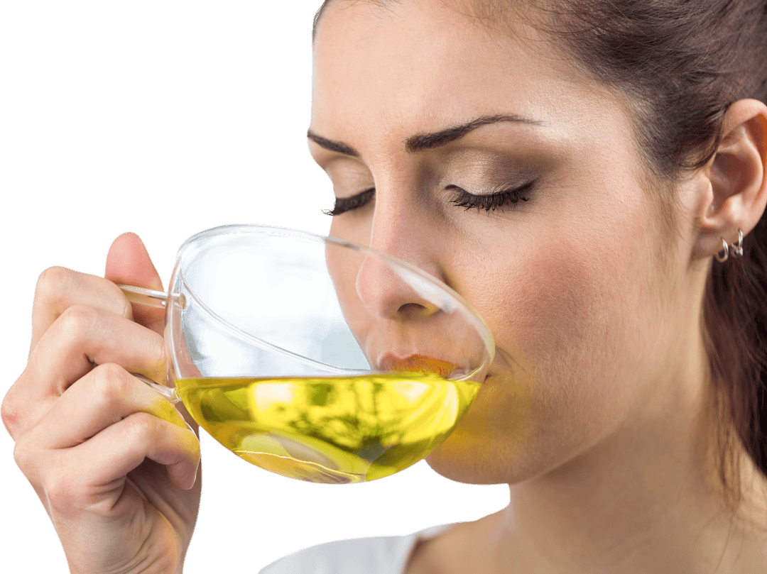 Calm Woman Enjoying Aromatic Herbal Tea in Transparent Cup