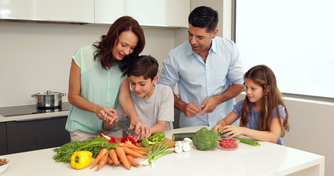 Happy Family Preparing Healthy Vegetarian Meal Together in Modern Kitchen - Free Images, Stock Photos and Pictures on Pikwizard.com