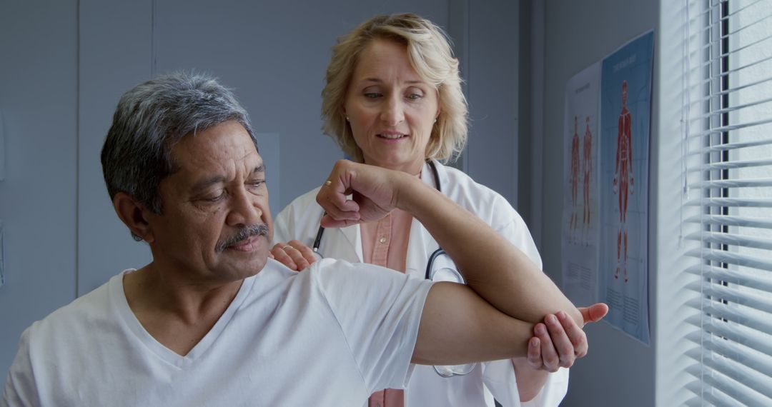 Doctor Examining Senior Patient's Arm in Medical Office - Free Images, Stock Photos and Pictures on Pikwizard.com