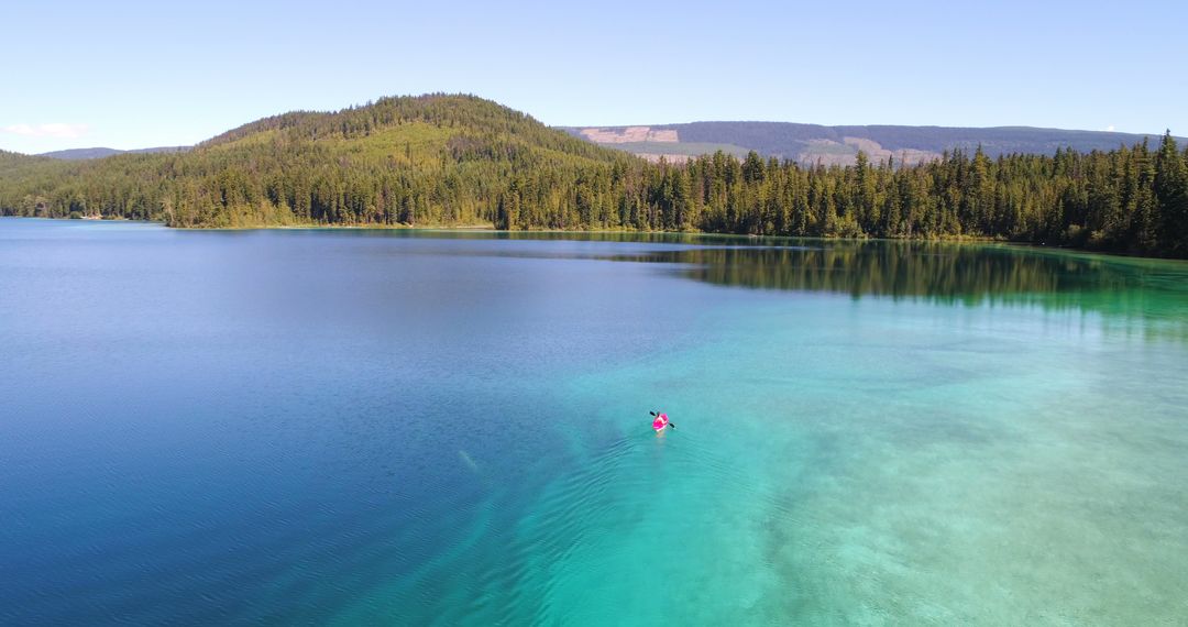 Aerial View of Crystal Clear Lake with Forest Landscape in Background - Free Images, Stock Photos and Pictures on Pikwizard.com