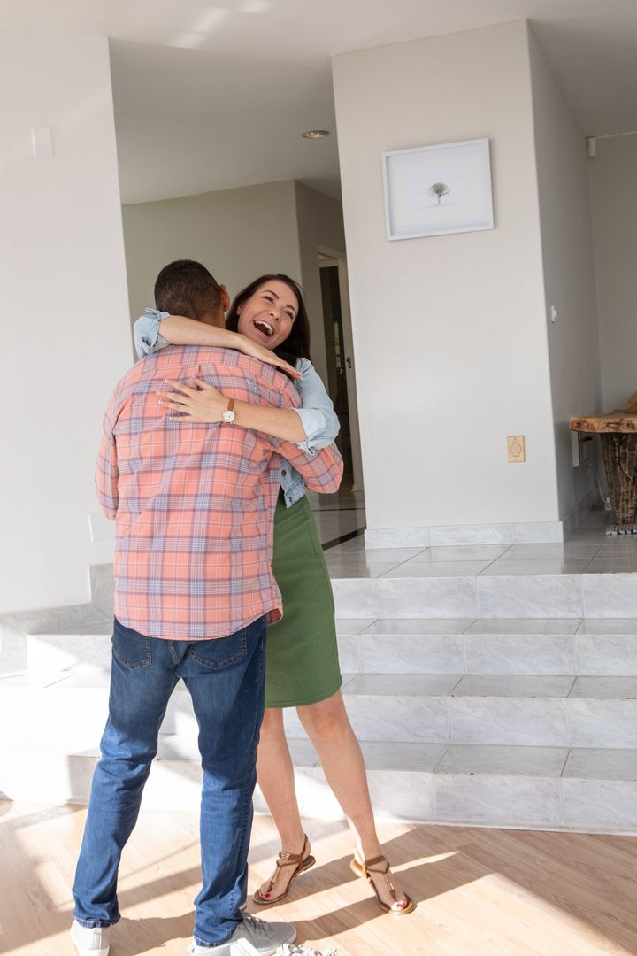 Warm Embrace in Sunlit Modern Entryway with Marble Steps