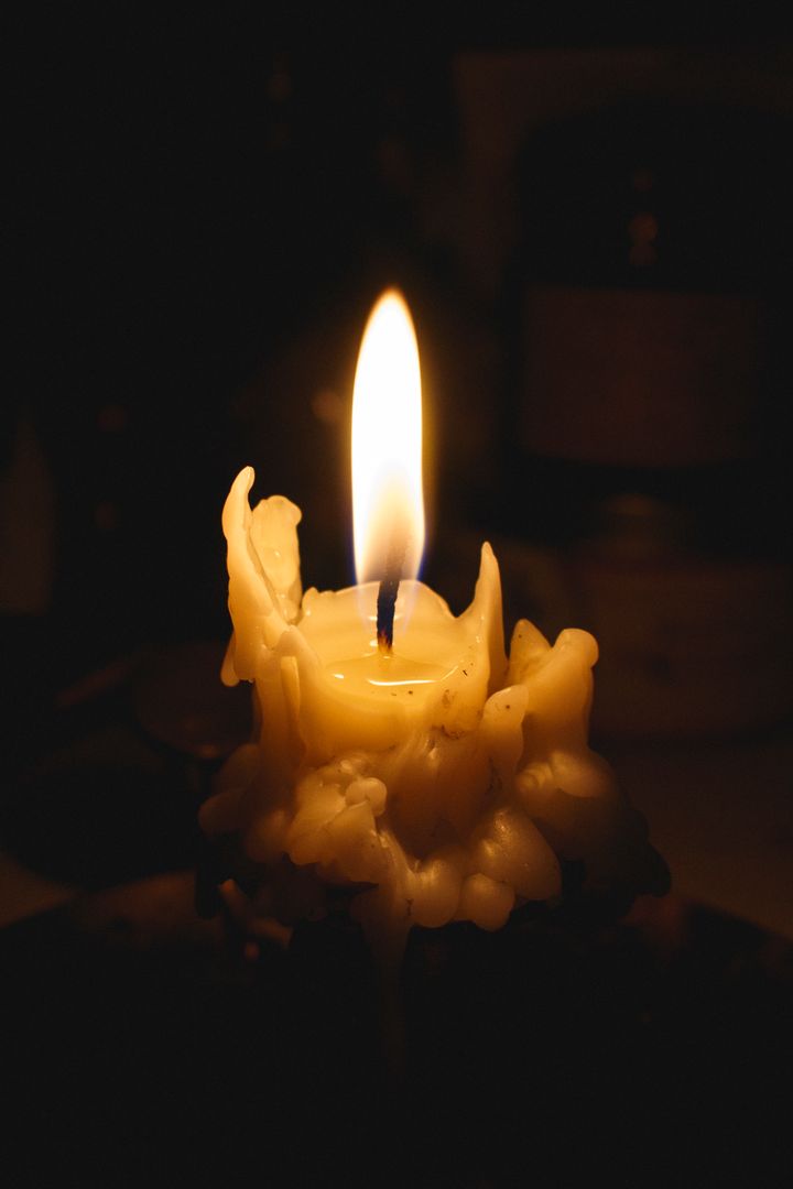 Melting Wax Candle with Bright Flame in Dark Background - Free Images, Stock Photos and Pictures on Pikwizard.com
