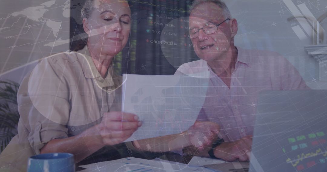 Senior Business Professionals Analyzing Financial Reports in Office