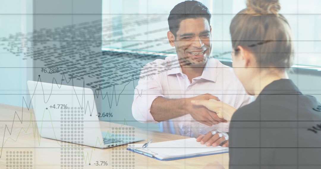 Business Partners Shaking Hands with Financial Data In Background