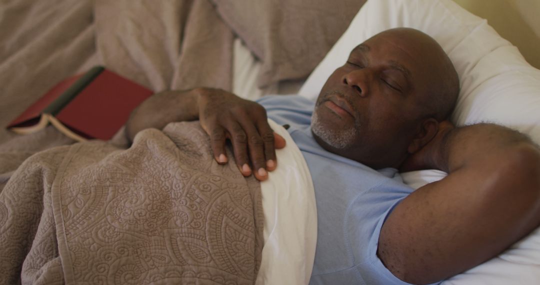 Senior Black Man Sleeping Peacefully in Bed with a Book Nearby - Free Images, Stock Photos and Pictures on Pikwizard.com