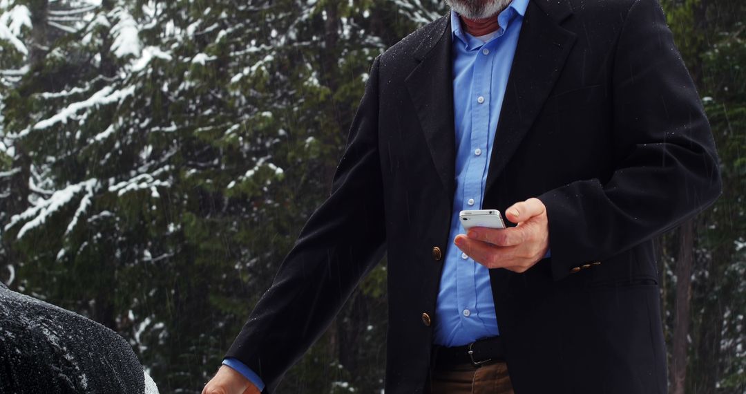 Businessman Using Smartphone Outdoors During Winter - Free Images, Stock Photos and Pictures on Pikwizard.com