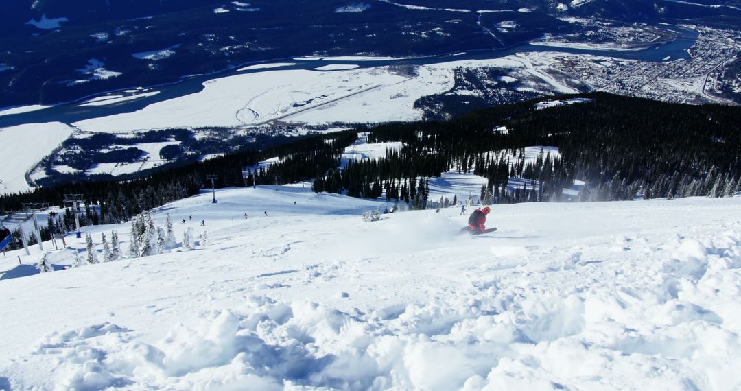 Skier Descending Snow-Covered Mountain with Scenic Valley View - Free Images, Stock Photos and Pictures on Pikwizard.com