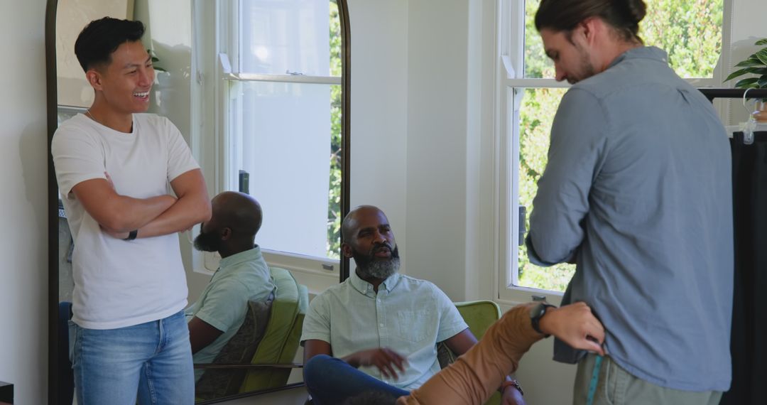 Friends Laughing as Tailor Measures Client for Custom Suit Fitting