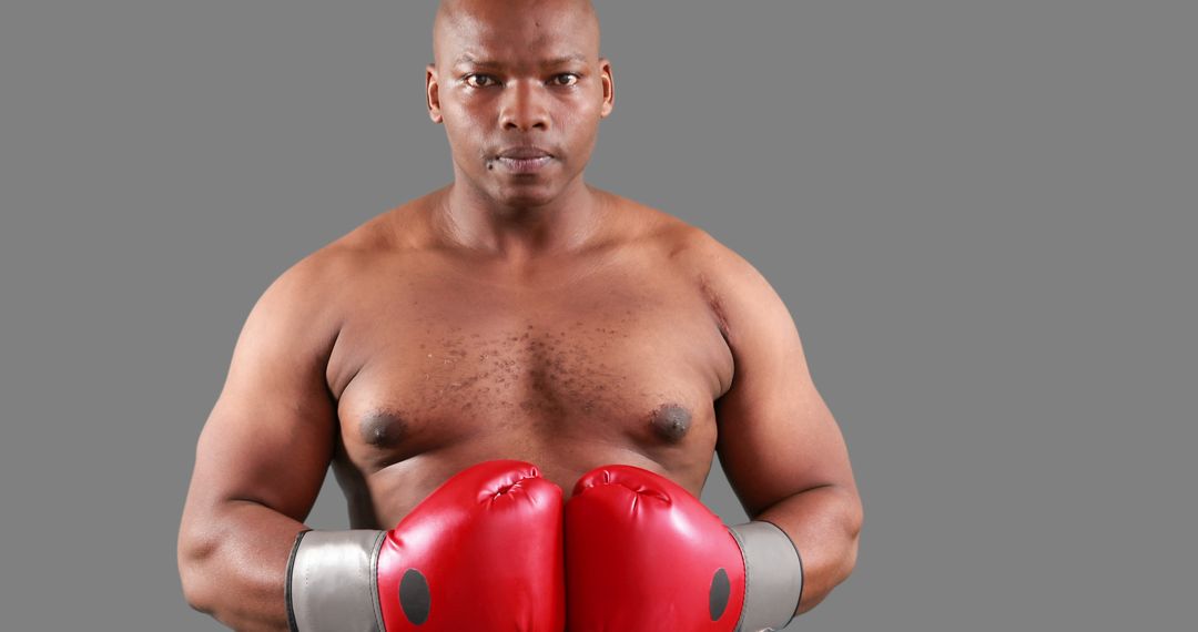 Confident Boxer with Red Gloves in Ring Stance - Free Images, Stock Photos and Pictures on Pikwizard.com